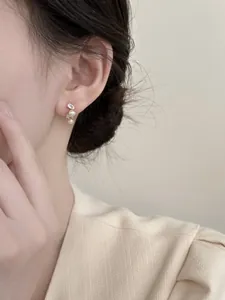 Elegant French style silver needle stud earrings featuring zircons and oval pearls