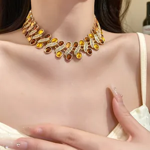 Vintage gold-tone collar necklace with amber resin cabochons and sparkling rhinestones
