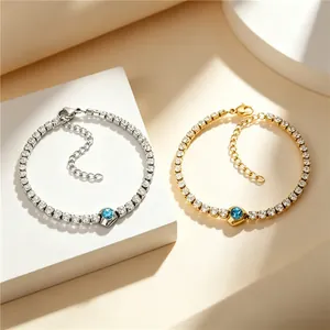 Detail of luxury square zircon bracelets in gold and silver finishes with blue center stones.