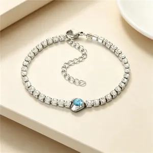 Close-up of titanium steel bracelet with square zircons and blue heart stone