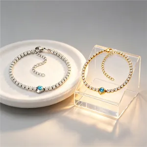 Detailed macro shot of gold and silver tennis bracelets with blue center stones on display.