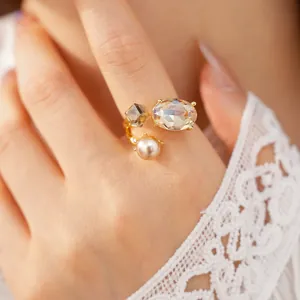 Elegant open ring featuring oval rhinestone, square crystal and pearl on model finger