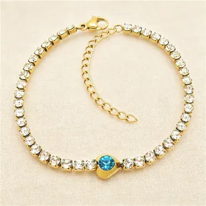 Detailed macro view of a gold titanium steel bracelet featuring a blue heart-shaped zircon