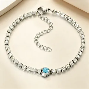 Detailed view of titanium steel tennis bracelet with central blue heart-shaped zircon.