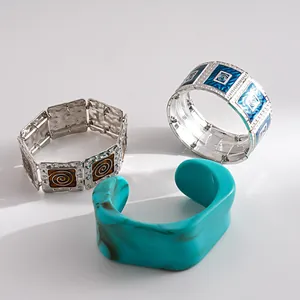 Set of three retro bracelets featuring blue enamel patterns and turquoise marbled resin