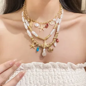 Detailed view of Bohemian multilayer necklace with pearl, starfish and shell charms