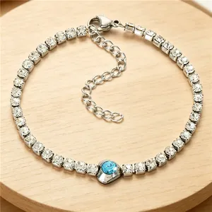 Detail showing a titanium steel bracelet with blue heart zircon and square CZ gemstones
