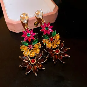 Glamorous multi-colored floral statement earrings featuring sparkling rhinestones and gold plating