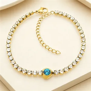 Detail view of a gold-plated tennis bracelet with blue heart zircon stone.
