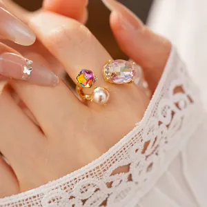Close-up macro detail of an elegant open ring with colorful crystals and pearl
