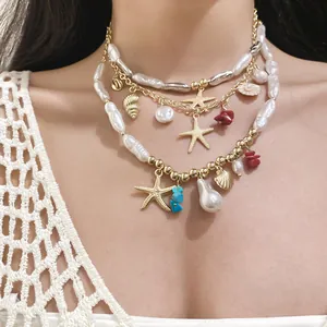 Close-up detail of a multi-layered gold chain necklace with baroque pearls and starfish