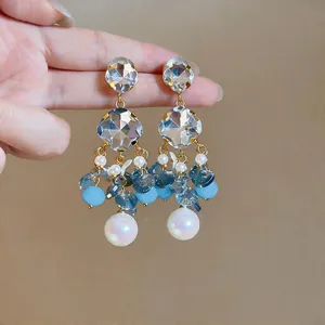 Detailed view of elegant blue beaded tassel earrings with crystals and pearls