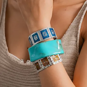 Close-up of retro enamel square stretch bracelets and turquoise resin bangle set