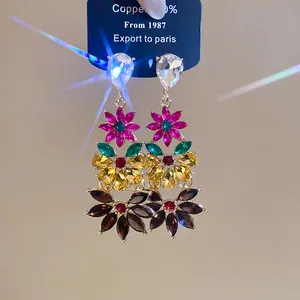 Detailed view of vibrant colorful crystal flower drop earrings with multi-layered petals
