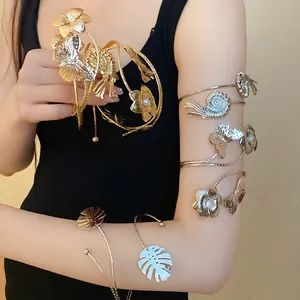 Elegant gold and silver metal arm cuffs with butterfly and floral designs for women