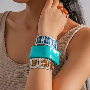 Detailed view of vintage enamel elastic bracelets and a chunky turquoise resin bangle.
