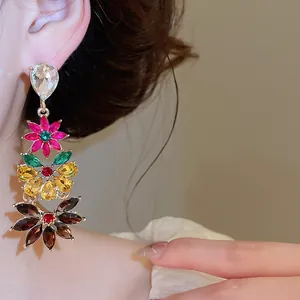 Detailed view of vibrant multi-color crystal flower earrings with dangling design