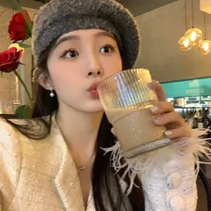 Elegant star zircon and pearl drop earrings shown worn by an Asian model in a cafe setting.