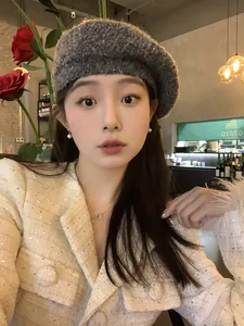 Detail view of elegant pearl drop earrings worn by an Asian model in a cafe setting
