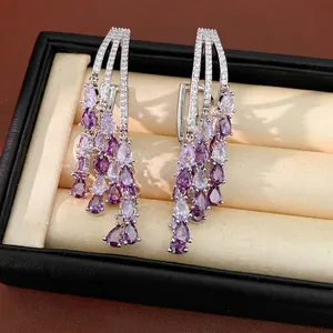 Elegant 18k gold plated silver tassel earrings with purple teardrop zircons in a box.