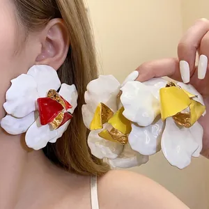 Large vintage metal flower stud earrings with enamel oil drip finish shown on Asian model