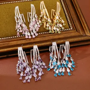 Detail view of luxury 18k gold plated zircon waterdrop tassel earrings in four colors