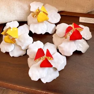 Retro white flower stud earrings with red and yellow centers in metal drip oil style
