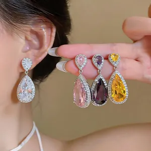 Detail view of luxurious teardrop zircon earrings in various vibrant colors for women