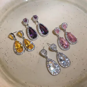 Detail view showing multiple vibrant colors of teardrop zircon earrings in a luxury style.