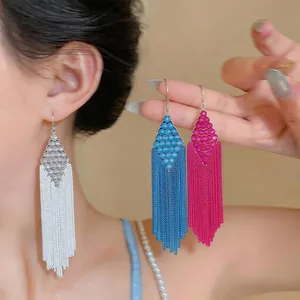 Macro view of long chain tassel earrings with rhombus bead details in three colors