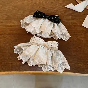 Elegant polka dot bow hair clips featuring delicate lace ruffles for a vintage look