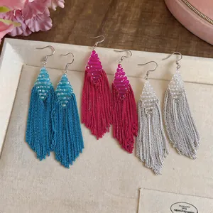 Detailed view of handmade diamond beaded long chain tassel earrings in three vibrant colors