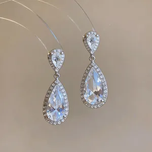 Detailed view of elegant teardrop-shaped zircon earrings with shimmering halo setting