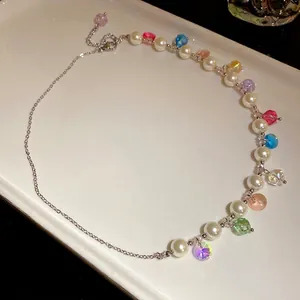 Asymmetric necklace featuring white pearls and vibrant colorful crystal beads for beach style