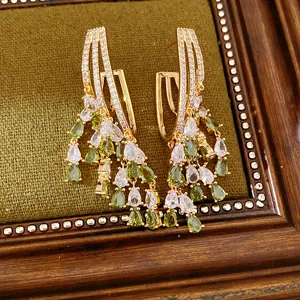 Close-up of 18k gold plated tassel earrings with green and white water drop zircons