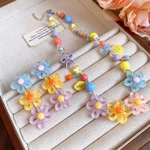 Vibrant colorful dopamine style daisy flower necklace and earring set in jewelry display