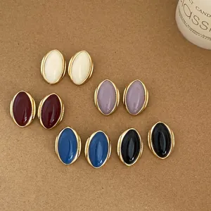 Detailed view of vintage oval stud earrings in multiple elegant colors with gold trim