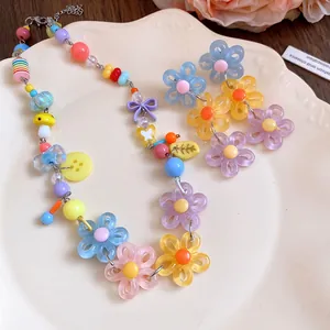 Vibrant dopamine style daisy beaded choker and floral earring jewelry set detail.