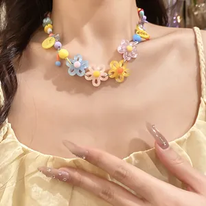 Detailed view of a colorful daisy beaded necklace in sweet dopamine style colors.