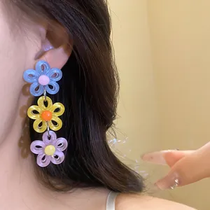 Vibrant dopamine style colorful triple daisy drop earrings for a sweet vacation look
