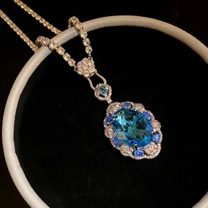 Elegant vintage royal style necklace featuring a large oval blue zircon pendant with halo