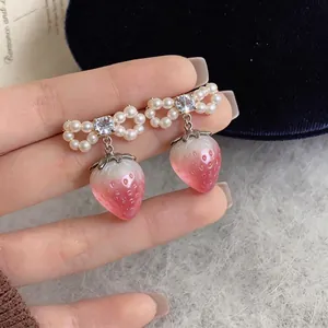 Elegant pearl bow earrings with pink strawberry drop and sparkling cubic zirconia