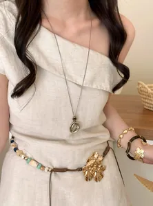 Elegant Korean style resin pendant necklace on a long metallic chain worn by a model