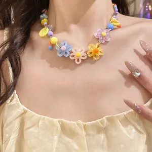 Detailed shot of colorful dopamine style daisy flower necklace with beads on model neck