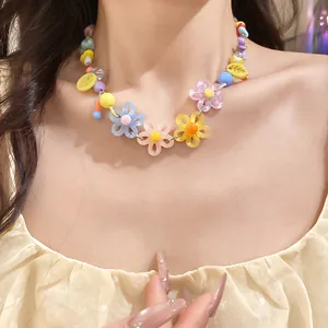 Close-up detail of a colorful dopamine-style daisy bead necklace worn by a female model