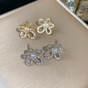 Close-up of exquisite 18k gold plated flower stud earrings with sparkling cubic zirconia.
