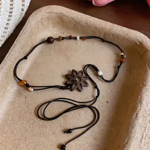 Elegant handmade boho leather cord necklace with coconut shell flower pendant and beads