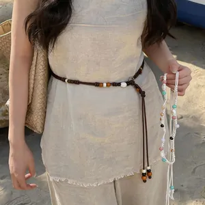 Bohemian braided waist chain detail featuring natural wood beads and shell accents