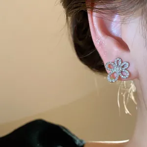 Macro view of exquisite zircon-encrusted flower stud earrings with 18k gold plating