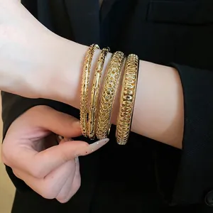 Elegant set of four gold-tone geometric hollow bangles for women, stylish metal jewelry